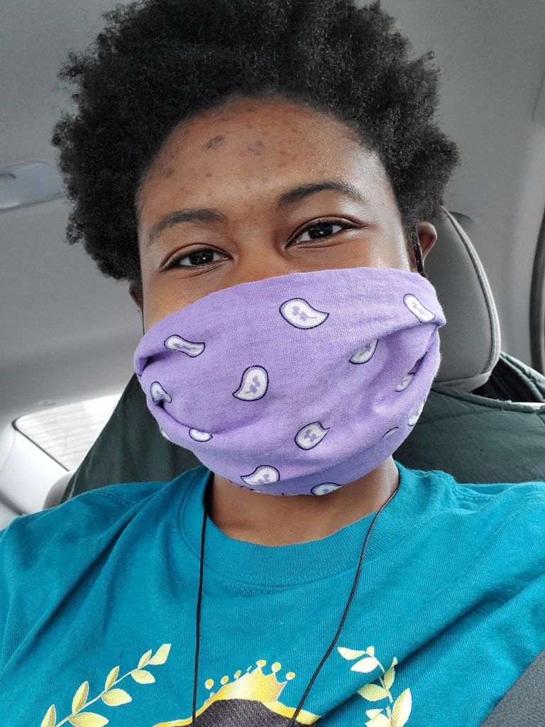 Picture of Desiree Robinson wearing a homemade face covering from a bandana and two ponytail holders.